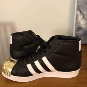 Adidas high top shoes. Gold tip